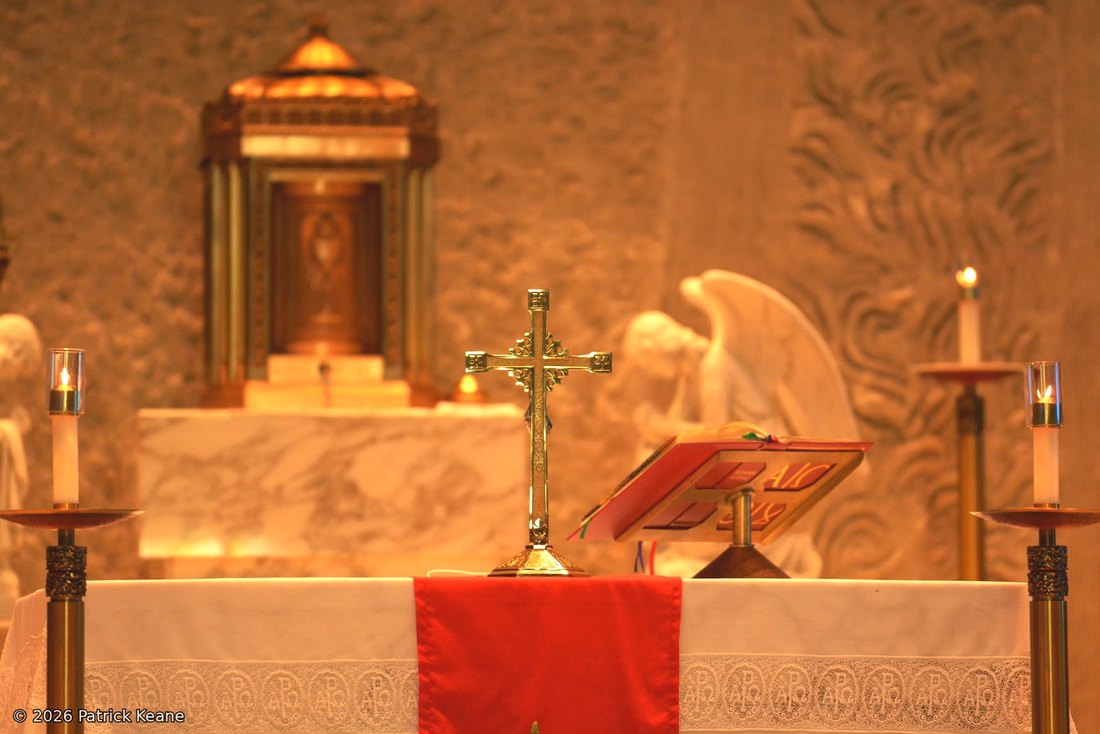 A church altar with crucifix, candles and tabernacle