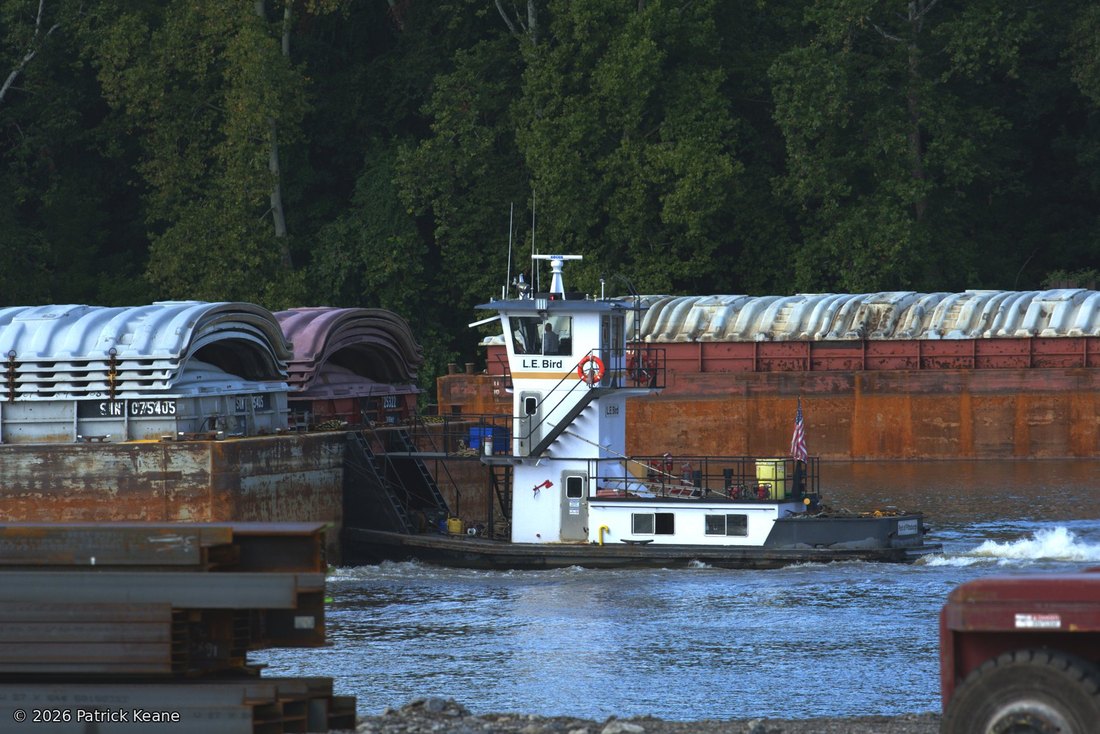 A towboat pushing covered barges on the Ohio River